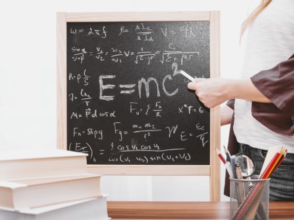 Chalkboard full of equations including E=MC2