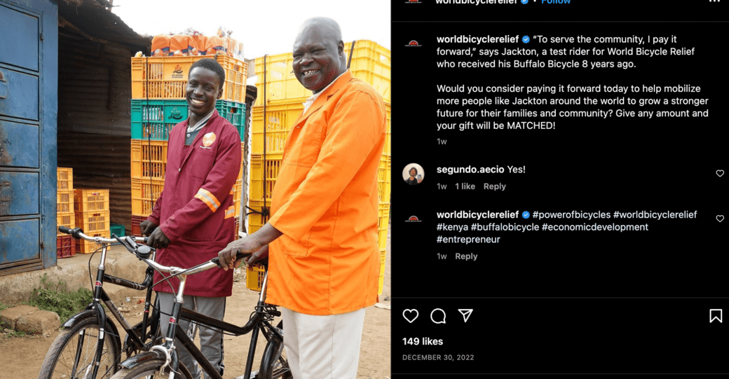A screenshot of a post from World Bicycle Relief featuring a photo of two men holding bikes and smiling.